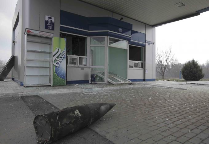A part of ammunition is seen scattered at a petrol station