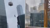 Terrifying moment helpless worker dangles from crane
